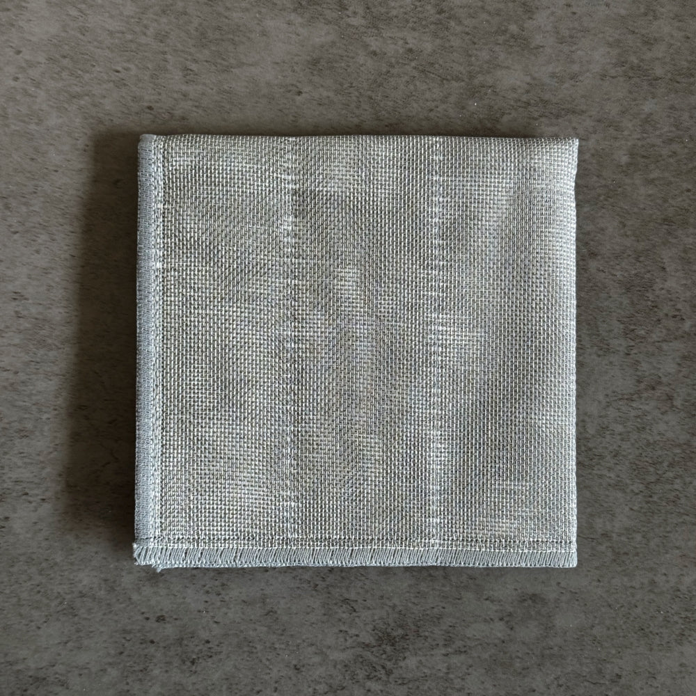 Folded Japanese grey kitchen cloth on a light grey background