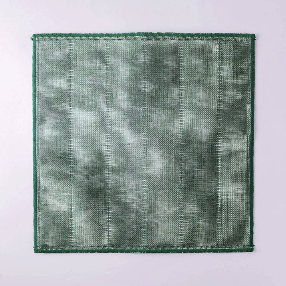 Green Japanese kitchen cloth on a grey background