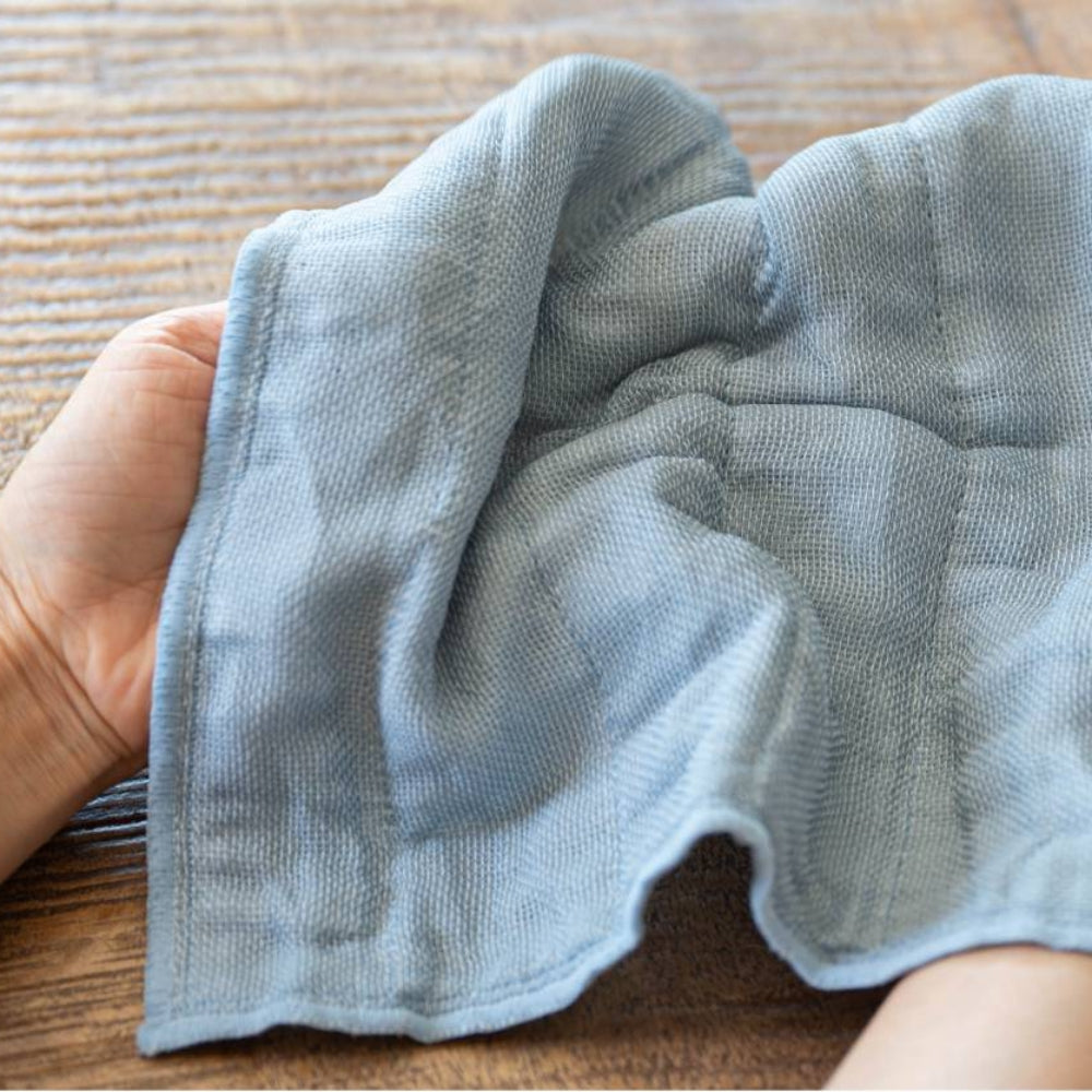 Green Japanese kitchen cloth on a grey background