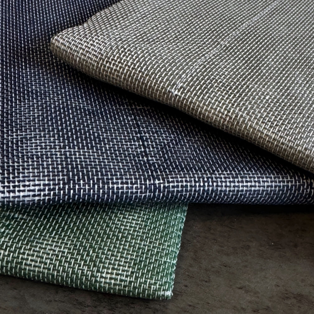 Close-up of textured fabric in various colors on a dark surface