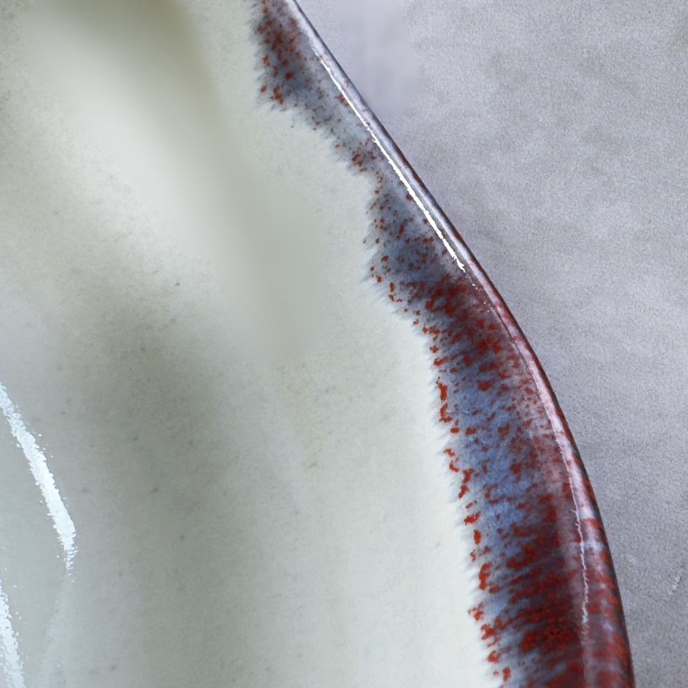 Close-up of a ceramic plate with a textured edge